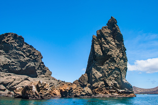 Ecuador. Galapagos. Picturesque rock in the Pacific. Nature of Ecuador. Volcanic island. Travelling to the Galapagos. A huge rock on the shore. Tourist attraction.