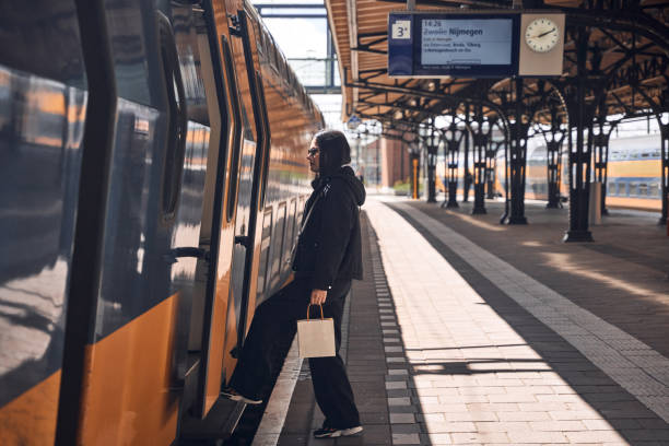 istock young woman is getting on the train 2149865961