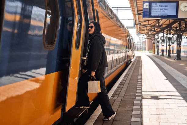 istock young woman is getting on the train 2149865969