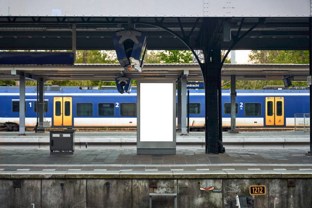 Blank information billboard or timetable located on train (s-bahn, u-bahn, metro) station. Railroad track on the bottom of the picture. Mock up design.