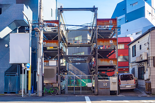 Japan. Automated parking station in Tokyo. A parking place in Japan. A multi-storey car park in the middle of buildings. Place for car-park in Tokyo. Car-park in a densely built-up area