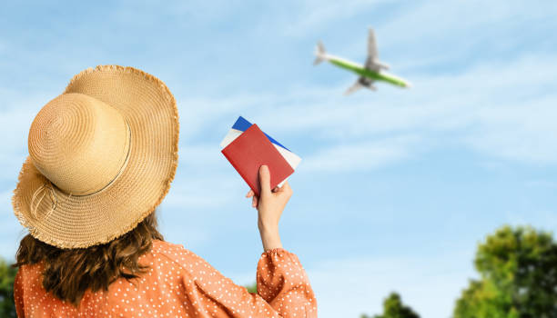 woman with tickets and passport in hands