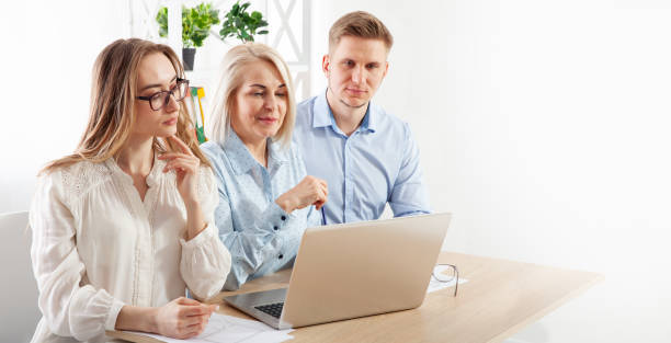 istock A proficient businesswoman is guiding and instructing young workers within the office. Selective focus. 2149868630