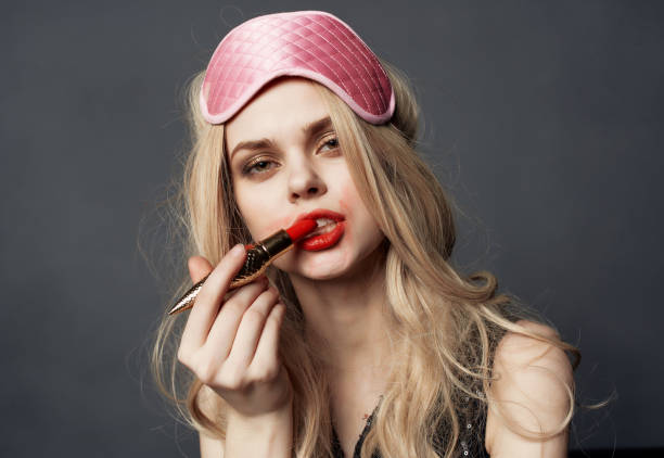 istock female smeared lipstick night life alcohol bottle dark background 2149868702
