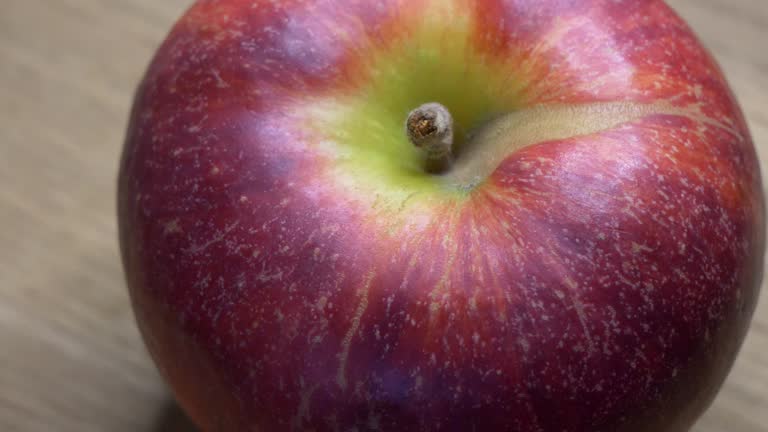Video with a rotating red apple. One large ripe gala apple in macro.