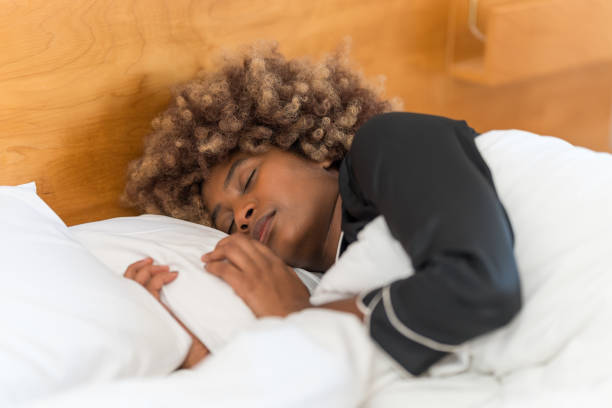 istock Woman peacefully sleeping in bed in the morning 2149869176
