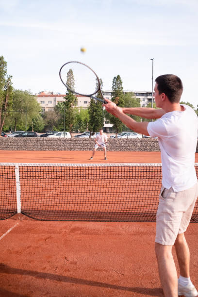 istock Two young men playing tennis outdoor 2149871066
