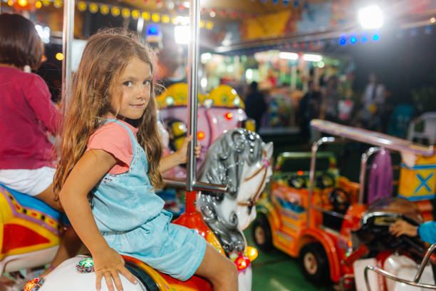 Little girls having fun at the amusement park