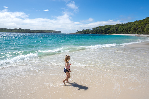 Young Girl Playing at a beautiful white sand beach in Eastern Australia