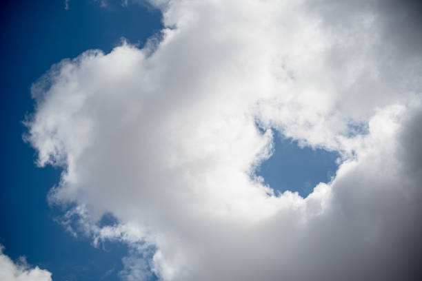 A picturesque scene of billowy clouds adorning the azure canvas of the sky, creating a tranquil ambiance in the springtime