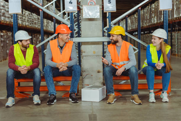 istock Successful, professional workers, engineers wearing hard hats and work wear talking, discussing 2149876934
