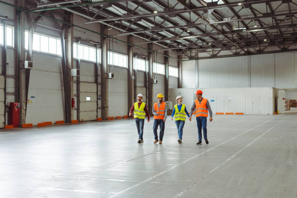 istock Group of smiling professional managers, engineers, workers walking in warehouse 2149876968