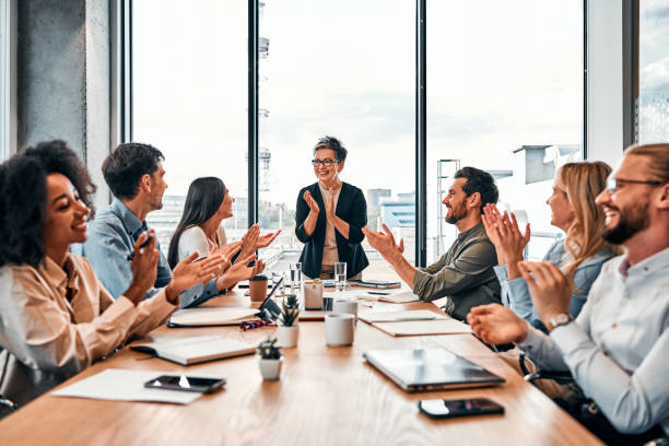 istock Successful team. Cheerful group of multinational colleagues celebrating gaining achievement with applause during meeting. 2149877166