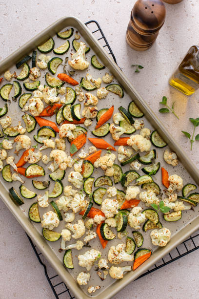Variety of roasted vegetables on a sheet pan ready to be eaten