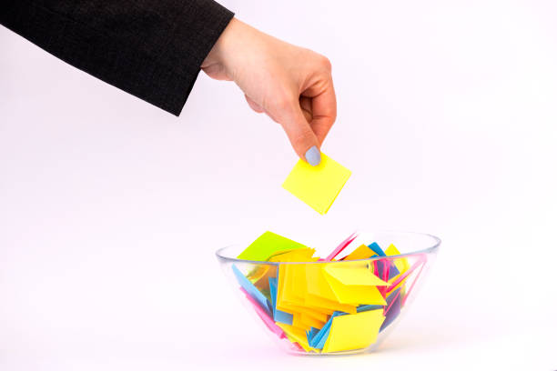 Draw lots. Folded colorful papers in bowl