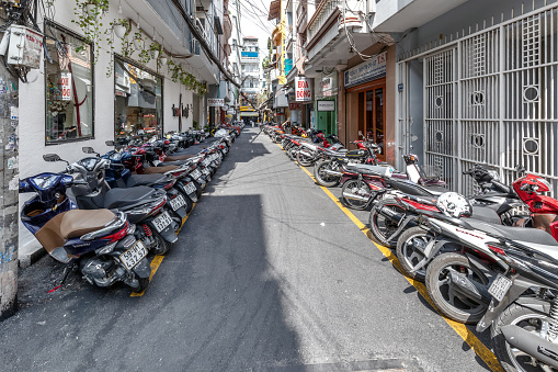 Ho Chi Minh, Vietnam - March 12, 2024: Lots of motorbikes parked on the street in the center of Ho Chi Minh City.