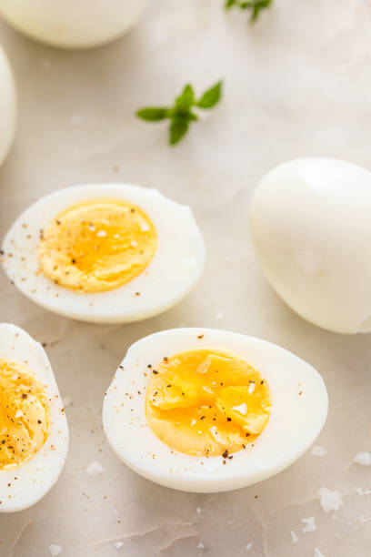 istock Boiled eggs peeled and cut in half with salt and pepper 2149879745