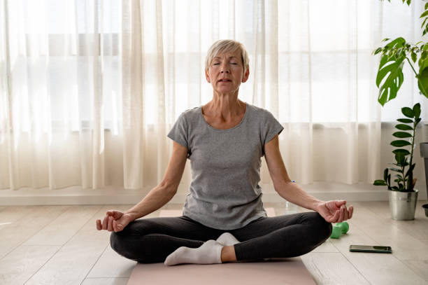 istock Active elderly woman practicing yoga indoors 2149880502