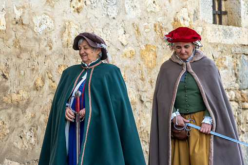 Torrelobatón, Valladolid-Spain, April 23, 2024; Two women represent the Roman era in an open-air medieval market, Women dressed as Romans in a Medieval village.