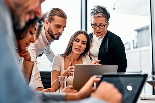 istock Research result on screen. Selective focus on serious business person explaining data from computer to employers. Enthusiastic managers learning useful tips and advices from experienced chief. 2149881462