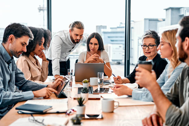istock Business meeting in progress. Multinational colleagues working on efficiency and collaborating for increasing productivity. Focused specialist using every possibility for reaching desirable goal. 2149881810