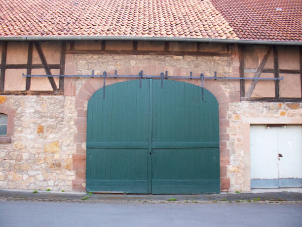 Weathered old wooden gate and door in timber frame house in a german village.
