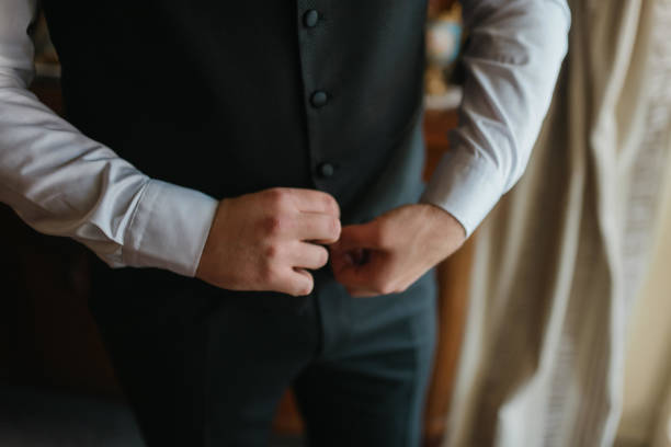 istock Guy is getting dressed for a business meeting. 2149884523