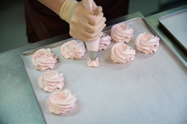 istock Sweet berry-flavored nests squeezing from pastry bag to the baking paper 2149887115