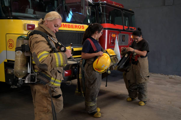 istock female firefighter preparing in front of the fire engine 2149888496
