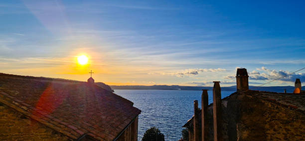 istock Sun shine over roof on a lake 2149888573