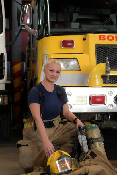 istock female firefighter posing in front of the fire engine 2149888625