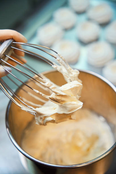 istock Professional woman baker whipping fruit puree with other ingredients 2149888973