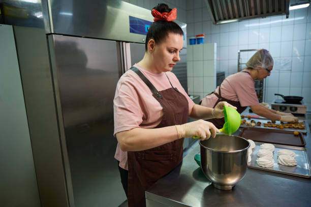 istock Two high-qualified women confectioner working on professional kitchen 2149889055