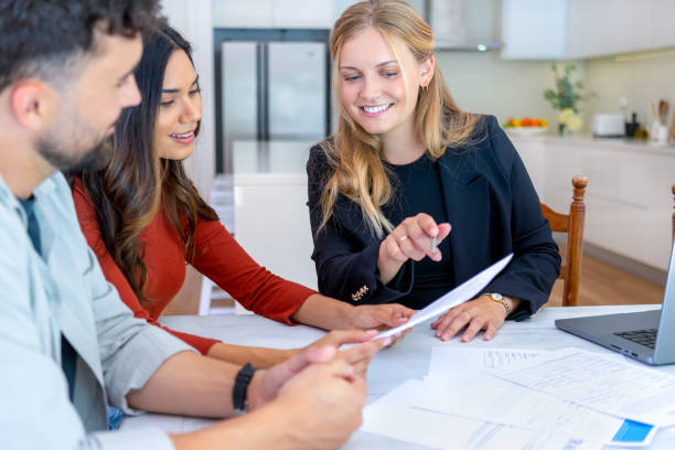 istock Real Estate or Insurance agent with couple looking through documents. 2149889068