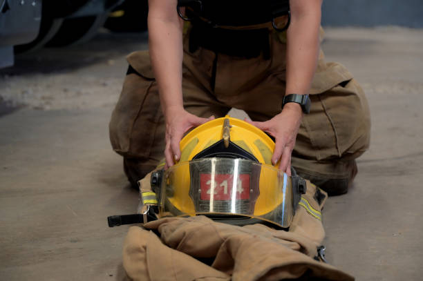 istock female firefighter putting on the helmet 2149889175