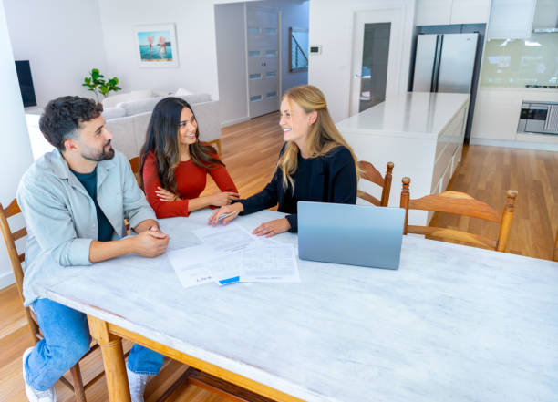 istock Real Estate or Insurance agent with couple looking through documents 2149889357