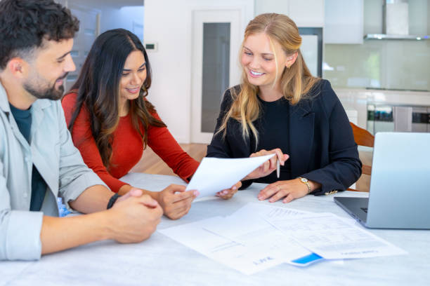 istock al Estate or Insurance agent with couple looking through documents 2149889557