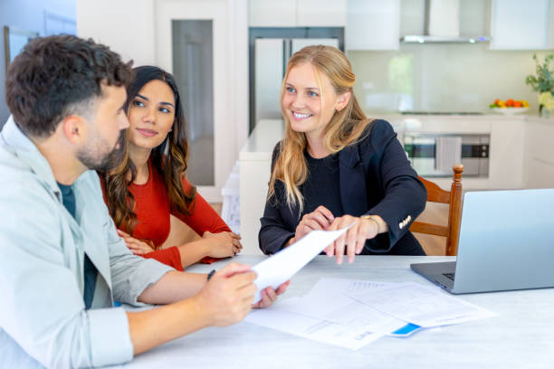 istock Real Estate or Insurance agent with couple looking through documents. 2149890136