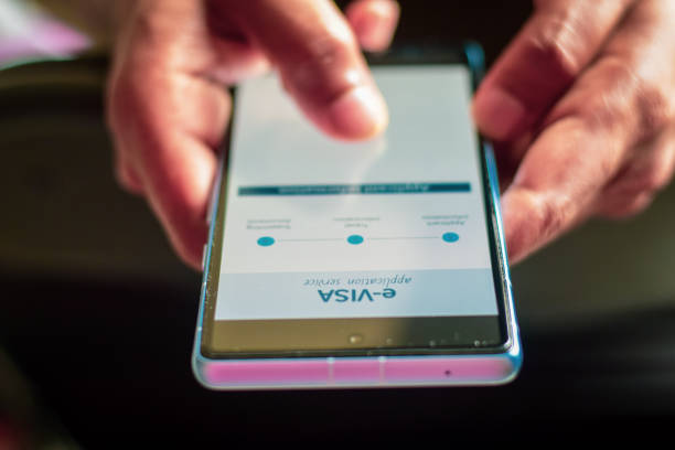 istock Man hand using phone to apply tourist e-visa online. Selective focus, benefits of applying electronic VISA tourism purposes. 2149893066