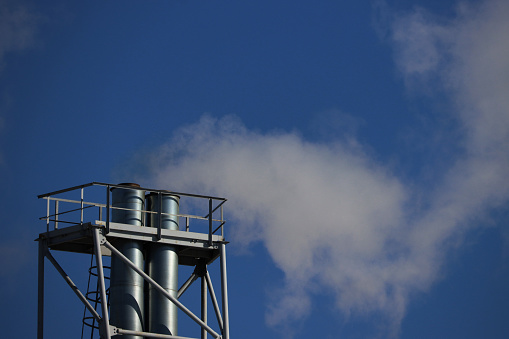 Environmental pollution. Industrial chimneys for exhaust emissions. Smoke from an industrial chimney.