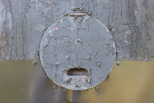 Close-up photo of a round technical hole with a cover.
