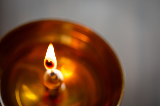 Lamp: Home temple burning lamp. Indian divine ritual to burn lamp in the temples. Commonly called diya. Shot on Monday, 15th April 2024 in Moncton, New Brunswick, Canada.