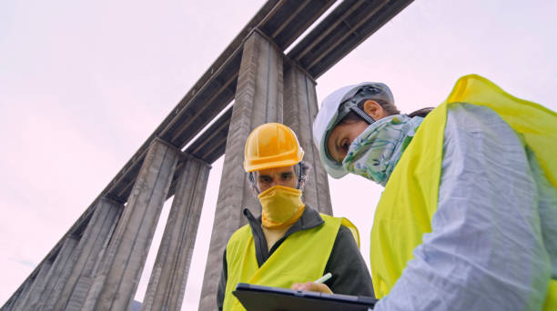 istock Road engineers working with protective face masks. Building new highways. 2149898204