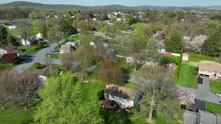 Establishing shot of small town in America. Homes in quiet quaint residential housing suburb. Aerial drone view.