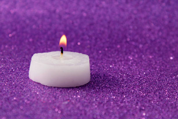 Scented candle in a jar on a wood table