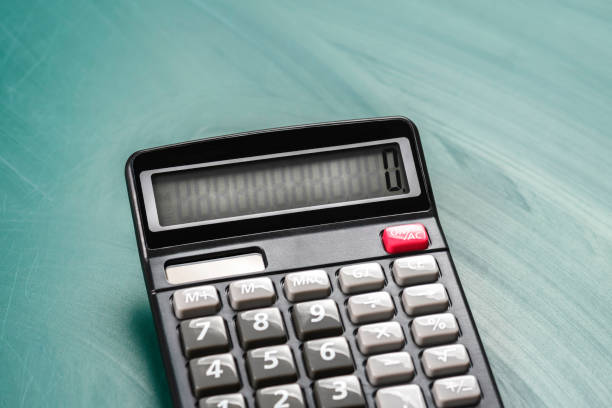 istock Digital calculator on green board with chalk stains. School and learning concept. Side view. 2149904069
