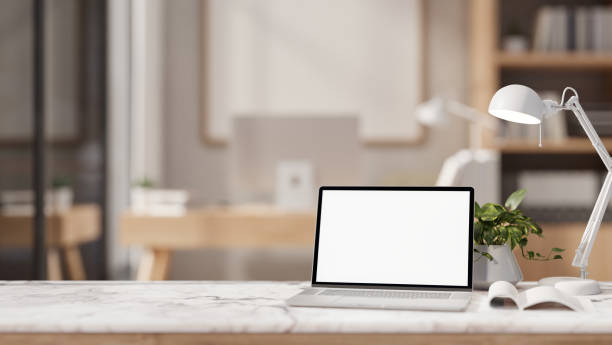istock The table showcases a white-screen laptop computer in a contemporary office. 2149910604