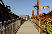 Historic exploration at Steelstacks. Tourist walking along the path, leading through an old steel plant in Bethlehem, PA