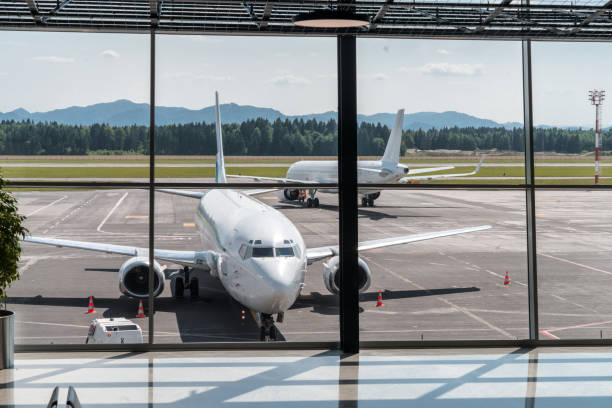 Empty airport departure lounge. Airplanes on the airfield.