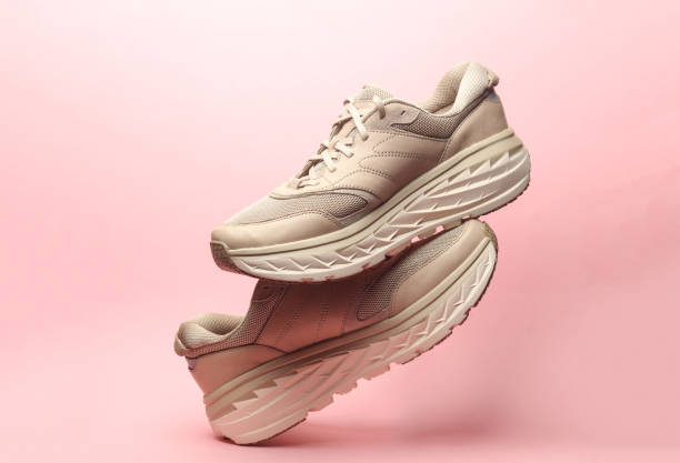 istock Sport sneakers floating on pink background 2149914532